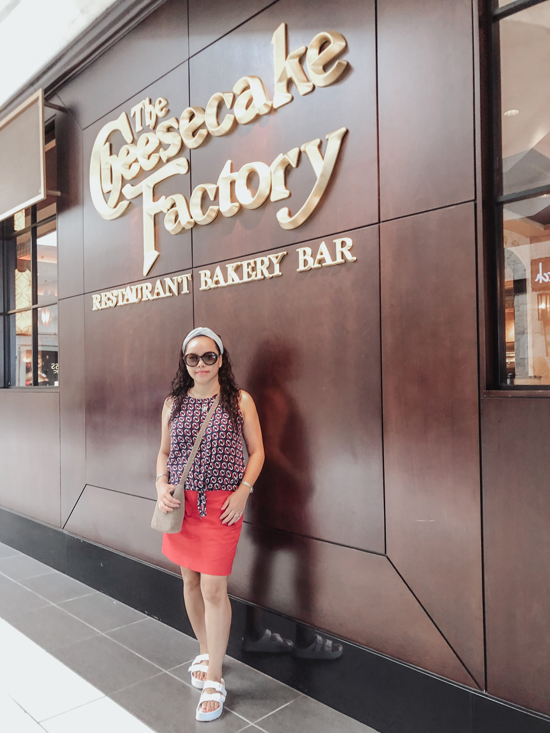 Cheesecake Factory, Ralph Lauren red skort/skirt, white sandals, light brown the sak bag, gucci sunglasses